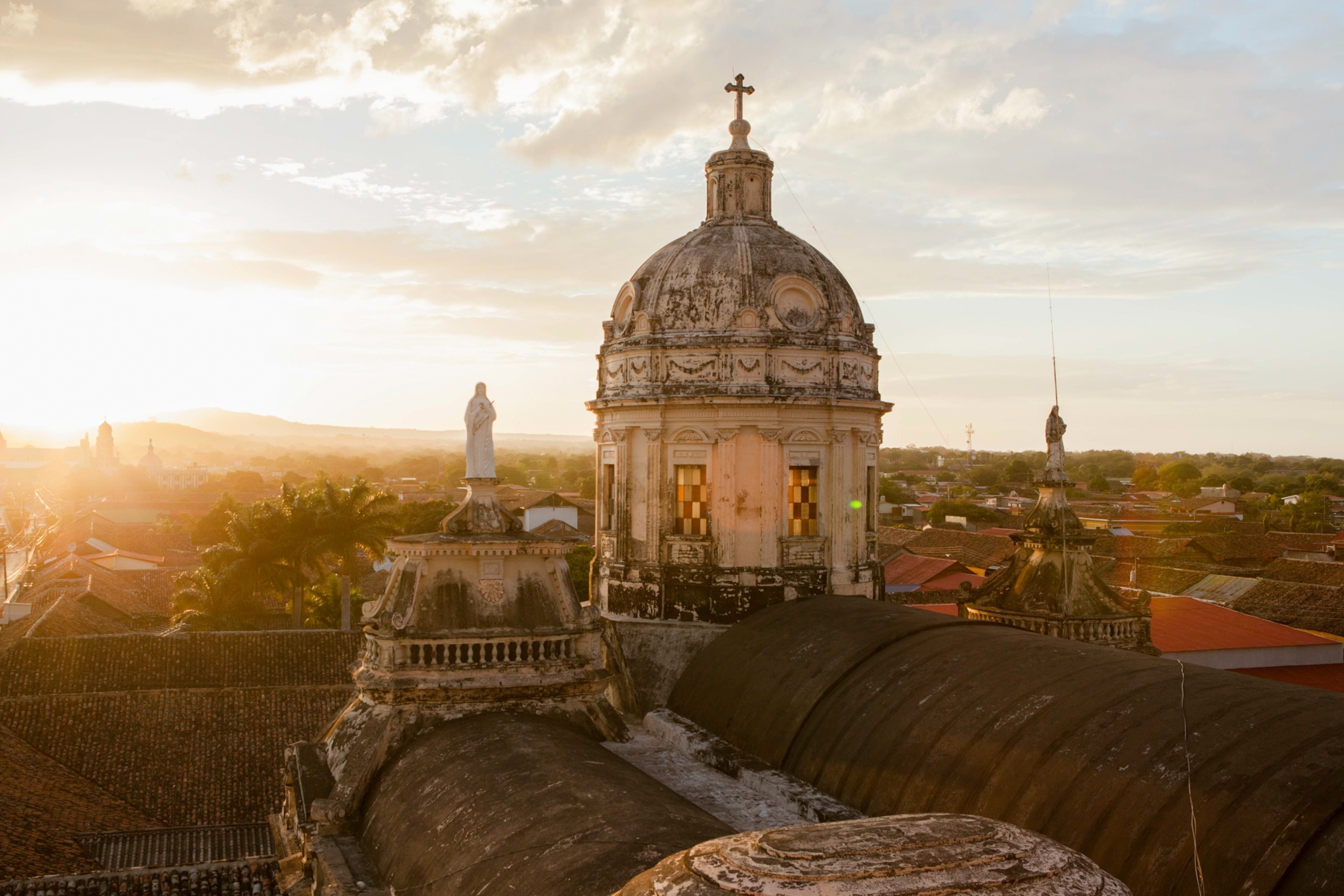 A view from the roof of an old church with hills of tropical foliage below.