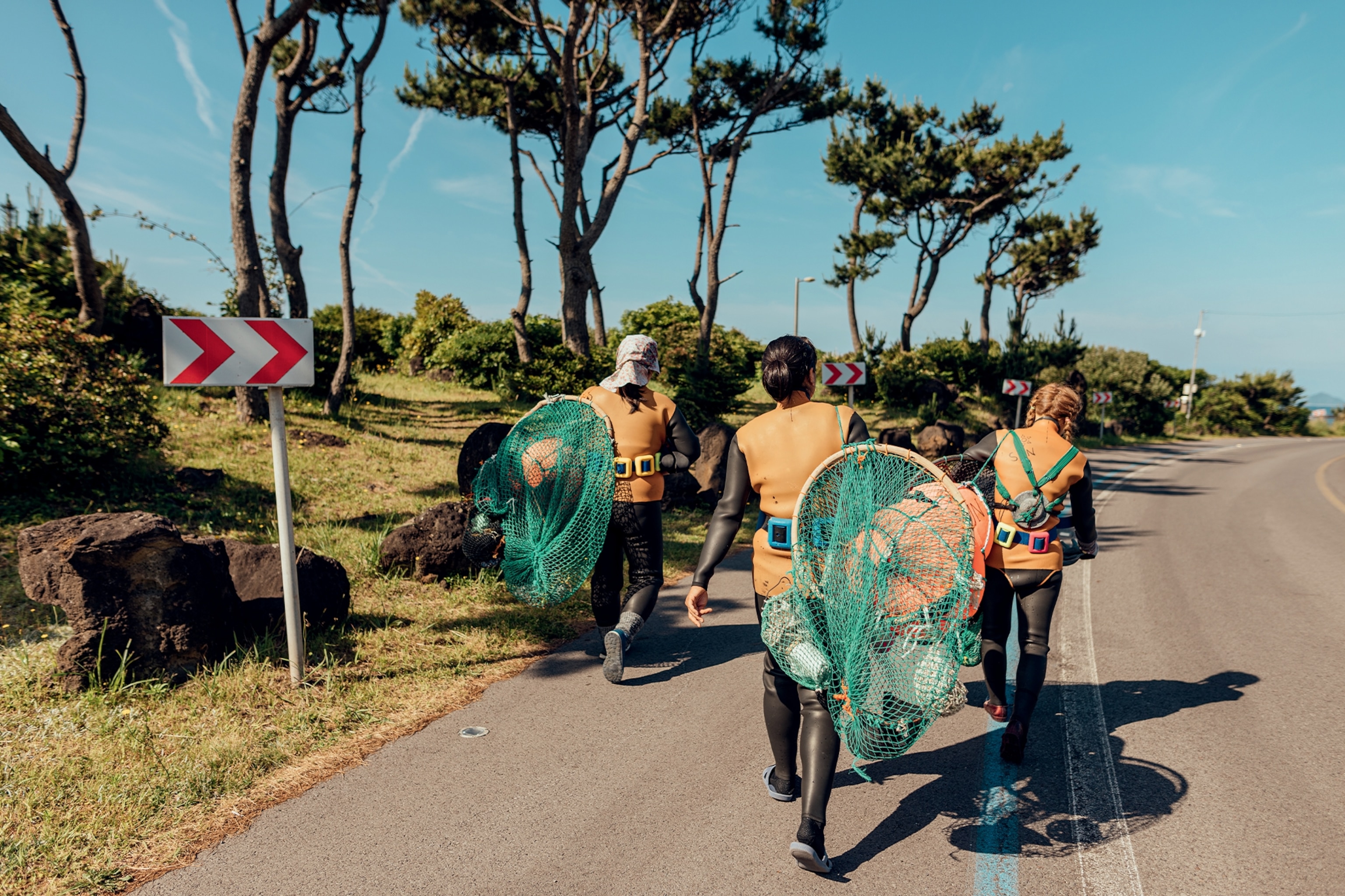 women carrying sea urchins