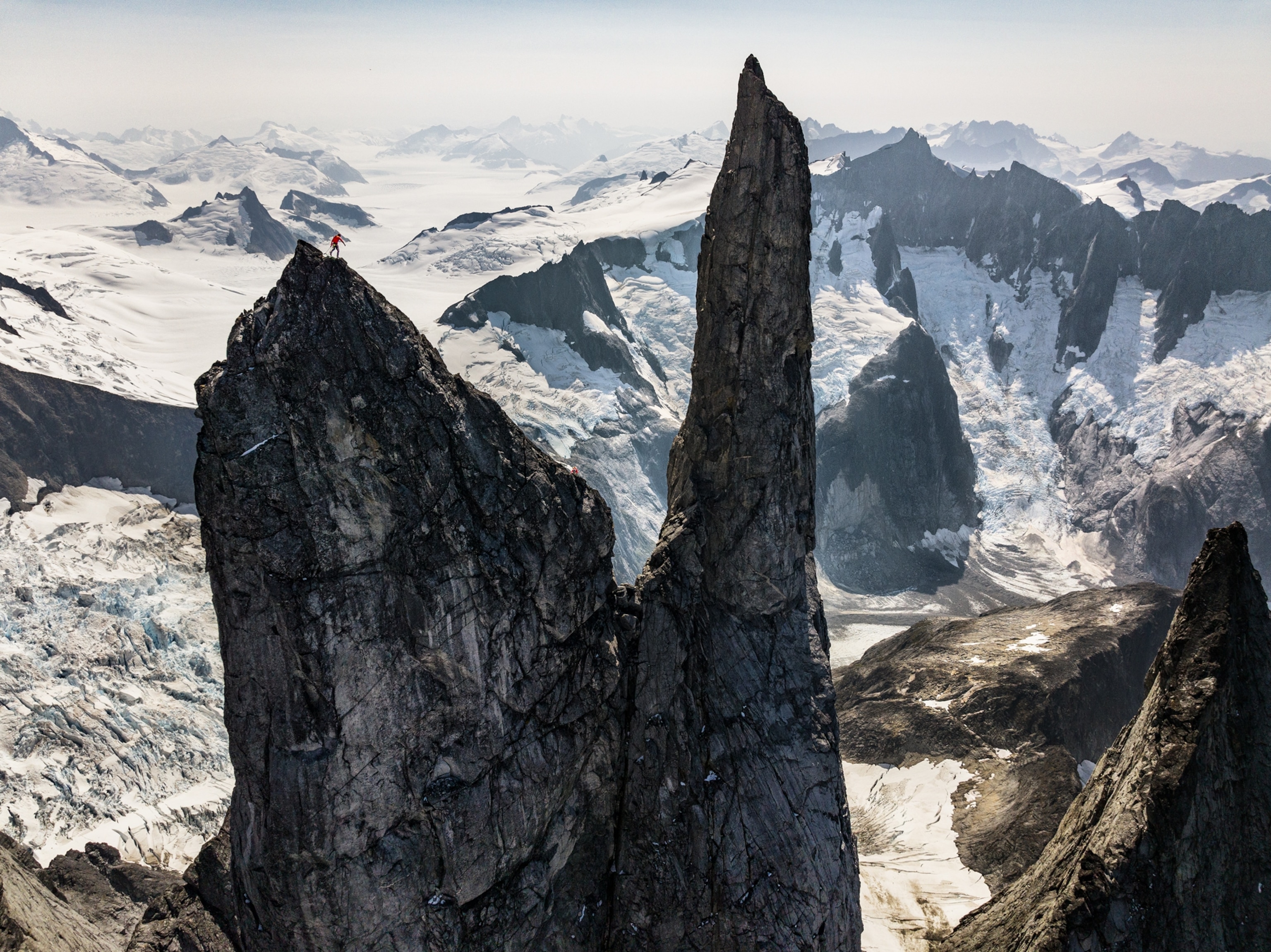 Aerial image of Devils Thumb with snowy mountains behind