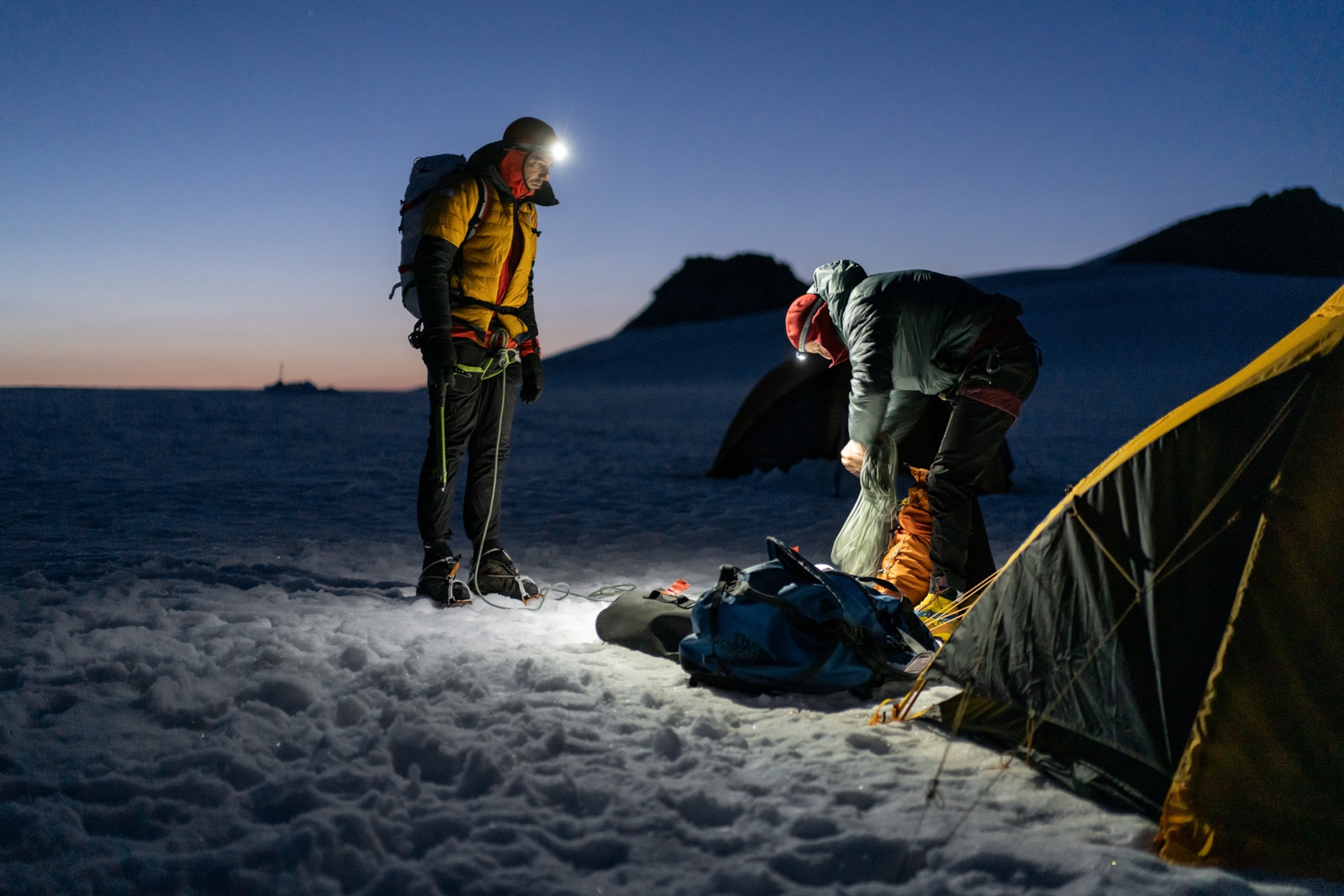 Honnals and Caldwell are wearing headlights gathering gear for their climb