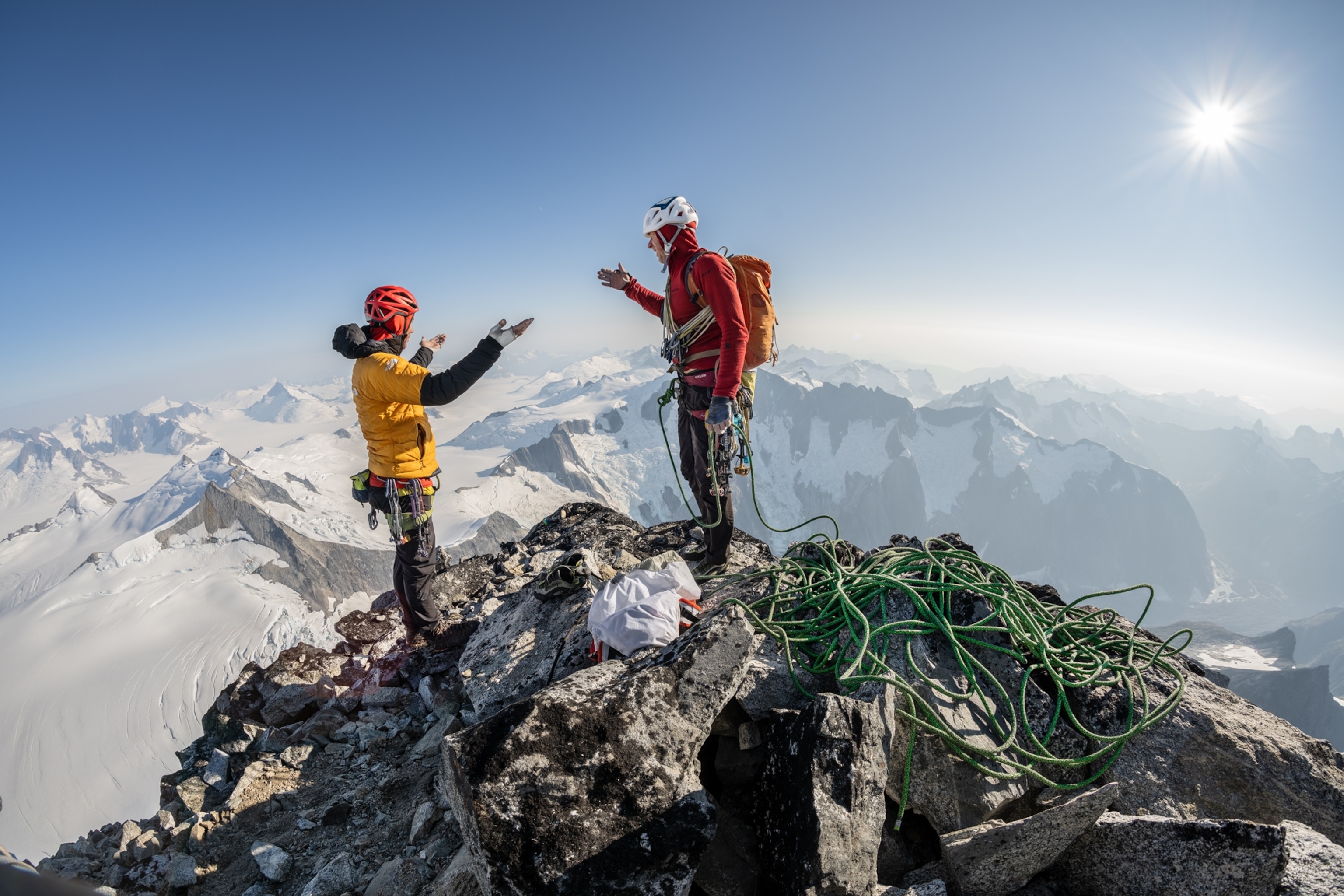 Honnold and Caldwell stand at the top of the Devils Thumb about to hi-five.