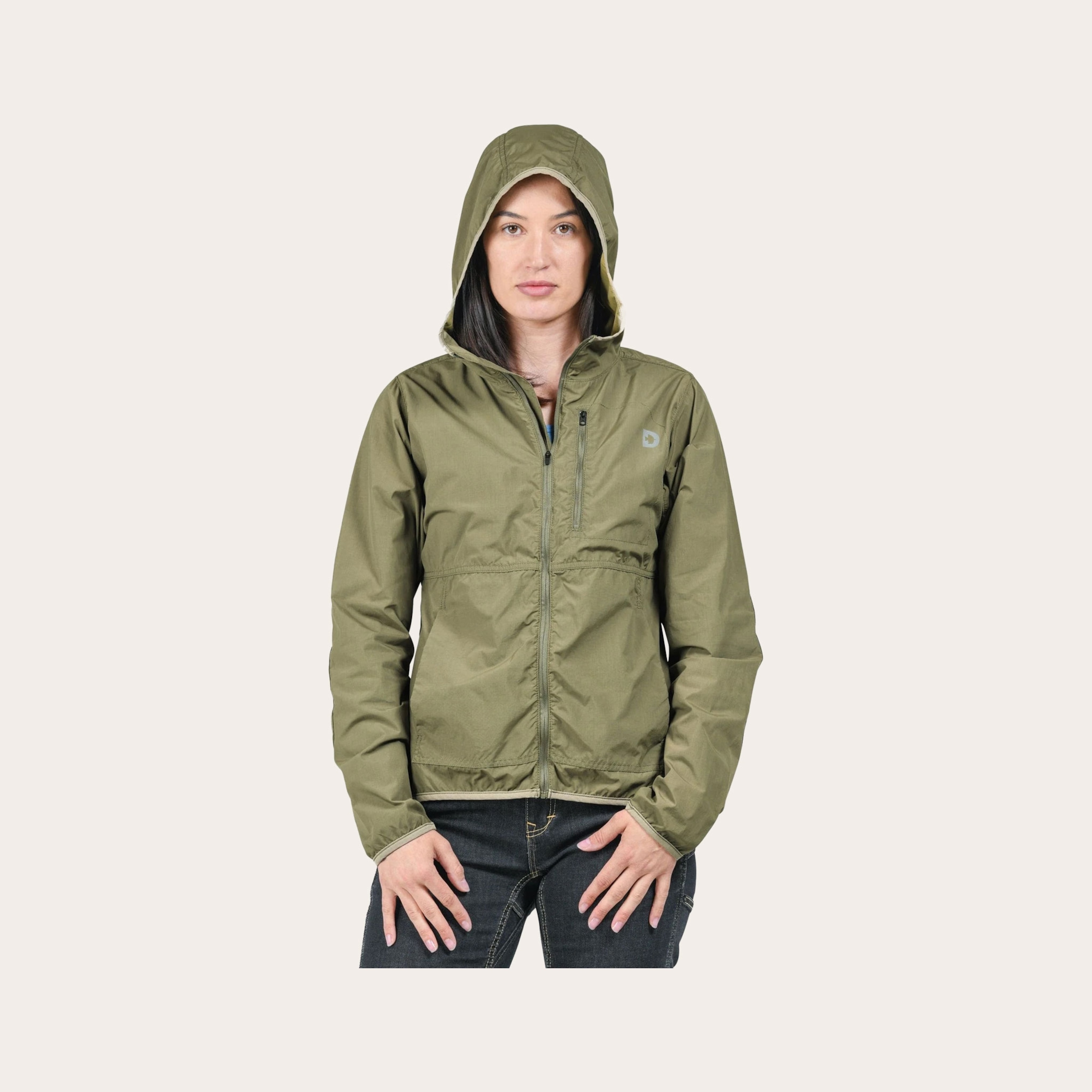 woman in green rain jacket placed on tan background